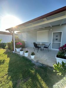 a patio with potted plants in front of a house at Theros 1 in Xanthi