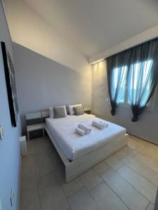 a bedroom with a bed with two towels on it at Theros 1 in Xanthi