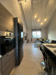 a kitchen with black appliances and a tile floor at Theros 1 in Xanthi +3 photos
