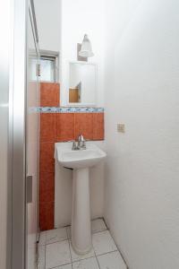 a bathroom with a sink and a mirror at Departamento Palmerín in La Paz +3 photos