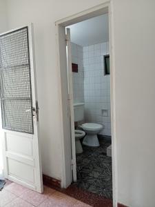 an open door to a bathroom with a toilet at Casa Centrica 5 Huésped in Pinamar +6 photos