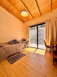 a bedroom with a bed and a large window at Casa Amapola in José Ignacio