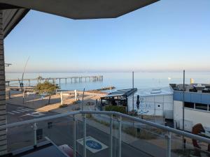 a view of the ocean from the balcony of a building at Fabelhaft am Meer in Timmendorfer Strand