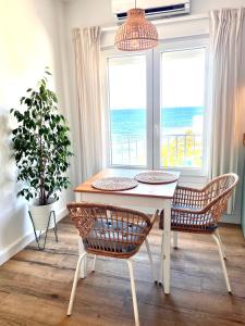 a dining room with a table and two chairs at Studio on the Beach Front in Sitio de Calahonda
