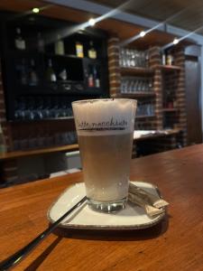 a drink sitting on a plate on a table at Hotel Tristan Grün in Rheine