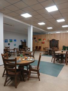 a dining room with wooden tables and chairs at Aiakeskuse hostel in Rakvere +11 photos