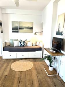 a living room with a bed and a desk at Studio on the Beach Front in Sitio de Calahonda