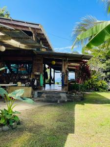 a wooden building with the ocean in the background at Open spacious house with stunning Peninsula view in Pavones