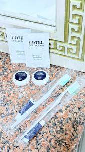 two toothbrushes sitting on a counter next to two boxes at Sultan Saray in Türkistan