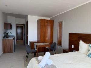 a bedroom with a bed and a desk and a kitchen at MIRAMARE Ocean View in Puerto Morelos +37 photos