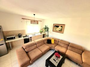 a living room with a couch and a kitchen at Appartament ZEA in Durrës