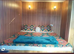 a large bed in a room with wooden walls at Swastik Guest House in Arambol +16 photos