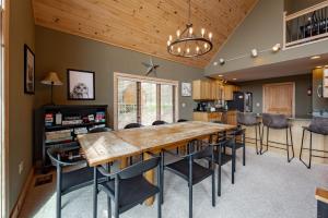 a kitchen and dining room with a wooden table and chairs at Chubby Bunny Lodge by Railey Vacations in McHenry