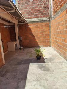a brick building with a potted plant in a courtyard at CasaJuan in Roldanillo +1 photo