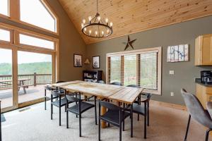 a dining room with a large wooden table and chairs at Chubby Bunny Lodge by Railey Vacations in McHenry