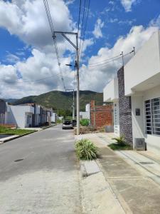 an empty street in a small town with a mountain at CasaJuan in Roldanillo