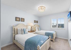 a bedroom with two beds and a window at Dune Pointe 402 - Shells, Surf & Sea Turtles in Fort Walton Beach +53 photos