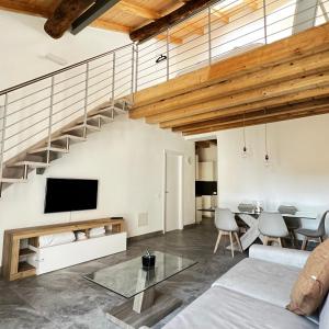 an open living room with a staircase and a table at R&V Apartments - Nel cuore di La Spezia in La Spezia