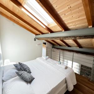 a bedroom with a large white bed with pillows at R&V Apartments - Nel cuore di La Spezia in La Spezia