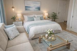 a bedroom with a large bed and a couch at Crayford's Guest House in Aberdeen