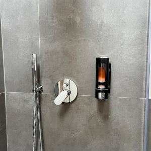 a bathroom with a shower with a soap dispenser at R&V Apartments - Nel cuore di La Spezia in La Spezia +51 photos