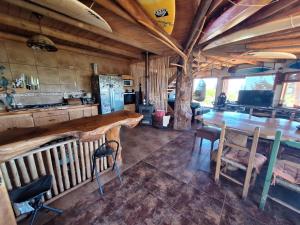 a kitchen with a large wooden table and chairs at Casacerrolacruz in Pichilemu