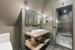 a bathroom with a sink and a shower at Lake Bomoseen - Lake Access, Fire Pit & BBQ in Castleton +52 photos