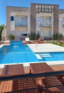 a swimming pool in front of a building at Resort Termal Chajarí in Chajarí