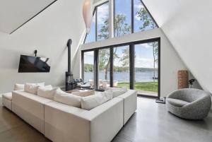 a living room with a white couch and a chair at Lake Bomoseen - Lake Access, Fire Pit & BBQ in Castleton