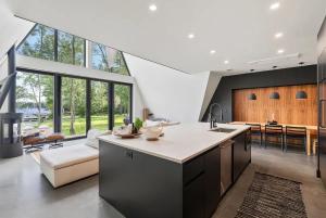 an open kitchen and living room with a large window at Lake Bomoseen - Lake Access, Fire Pit & BBQ in Castleton