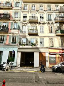 a motorcycle parked in front of a building at Meilleur emplacement de Nice Charming Flat #3 in La Celle-sous-Gouzon