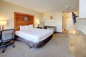 a hotel room with a large bed and a desk at Capital O Duncanville Tx in Duncanville