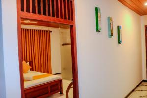 a bedroom with a bunk bed and a mirror at Nature Forest Villa in Hikkaduwa