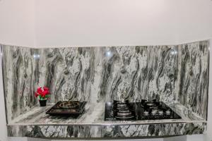 a kitchen with a counter with two burners on it at Nature Forest Villa in Hikkaduwa