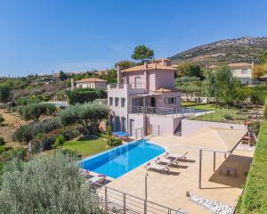 a villa with a swimming pool and a house at Villa Anna by Villa Select in Skala