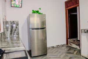a stainless steel refrigerator with a plant on top of it at Nature Forest Villa in Hikkaduwa
