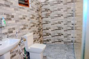 a bathroom with a toilet and a sink and a shower at Nature Forest Villa in Hikkaduwa +35 photos