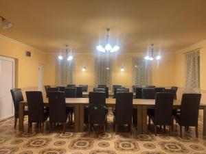 a conference room with a long table and chairs at Bencsik Vendégház in Szentkirály