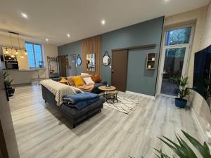 a living room with a couch and a table at HOME 102 Cosy in Lons-le-Saunier