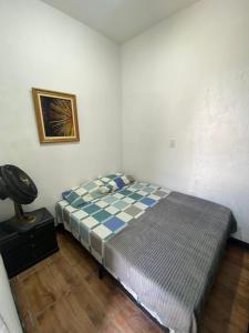 a bedroom with a bed and a phone in it at Praia dos Sonhos - Suítes in Itanhaém