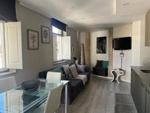 a living room with a couch and a table at Al Amoreirinha Rui Barata in Castelo Branco