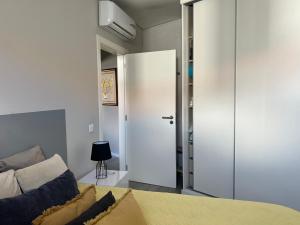 a bedroom with a bed and a sliding door at Al Amoreirinha Rui Barata in Castelo Branco