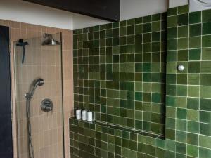 a green tiled shower in a bathroom at The Bald Seagle in Port Orchard