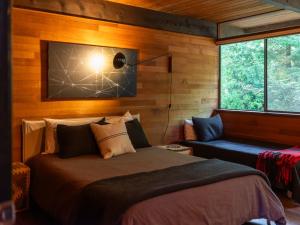a bedroom with a bed and a couch and a window at The Bald Seagle in Port Orchard
