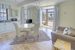 a kitchen and living room with a table and a couch at 1 Bed in Seaton oc-mbsov in Seaton