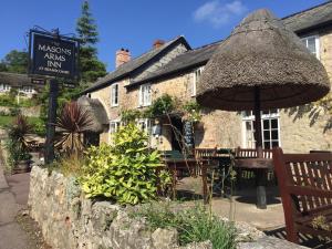 a restaurant with an umbrella and a table and chairs at 1 Bed in Seaton oc-mbsov in Seaton +14 photos