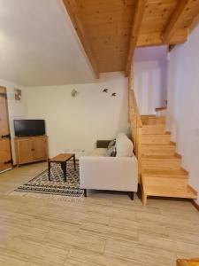 a living room with a white couch and stairs at Alba Odeceixe - casa clara in Odeceixe