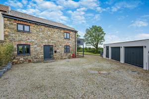 a stone house with a driveway and a garage at 2 Bed in St. Minver oc-r29475 in Saint Minver