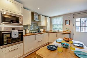 a kitchen with a table with plates on it at 2 Bed in Uplyme oc-s28314 in Uplyme +9 photos