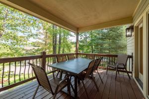 a screened porch with a table and chairs on it at Restful Retreat by Railey Vacations in Oakland
